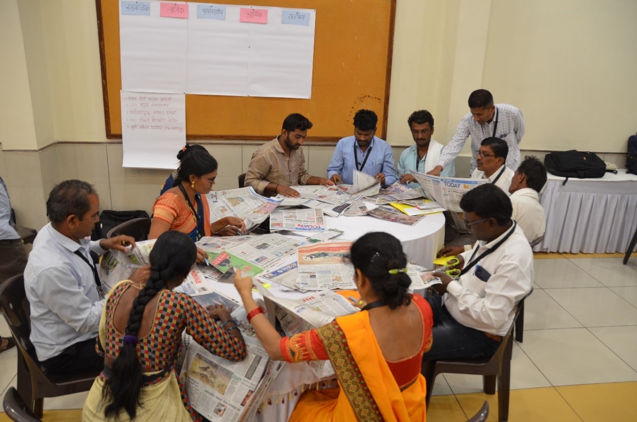 Participants analysing newspaper headlines at The Transformative Scenario Planning (TSP) Workshop for Farmer Producer Organisations